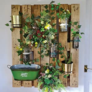  A vertical garden built on a wooden palette installed on a wall.