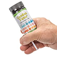 Matching 3 pad Garden Tutor soil pH test strip to color chart